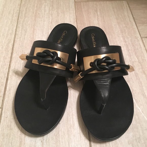 black sandals with gold trim
